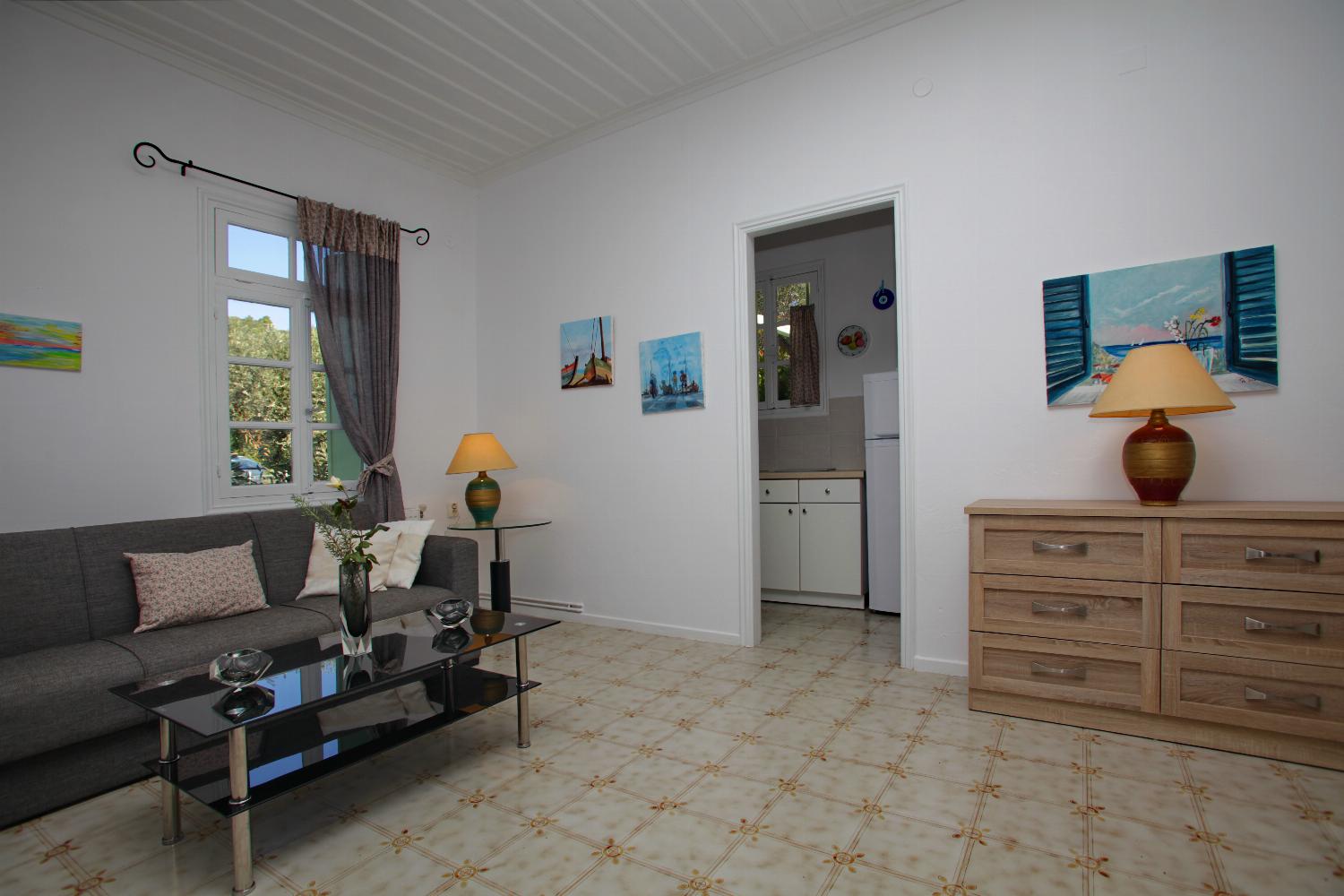 Open-plan living room with sofa, dining area, kitchen, WiFi internet, satellite TV
