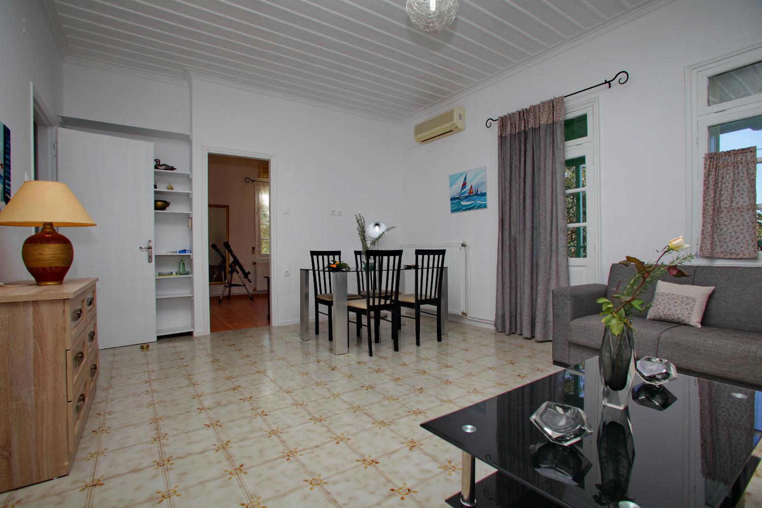 Open-plan living room with sofa, dining area, kitchen, WiFi internet, satellite TV