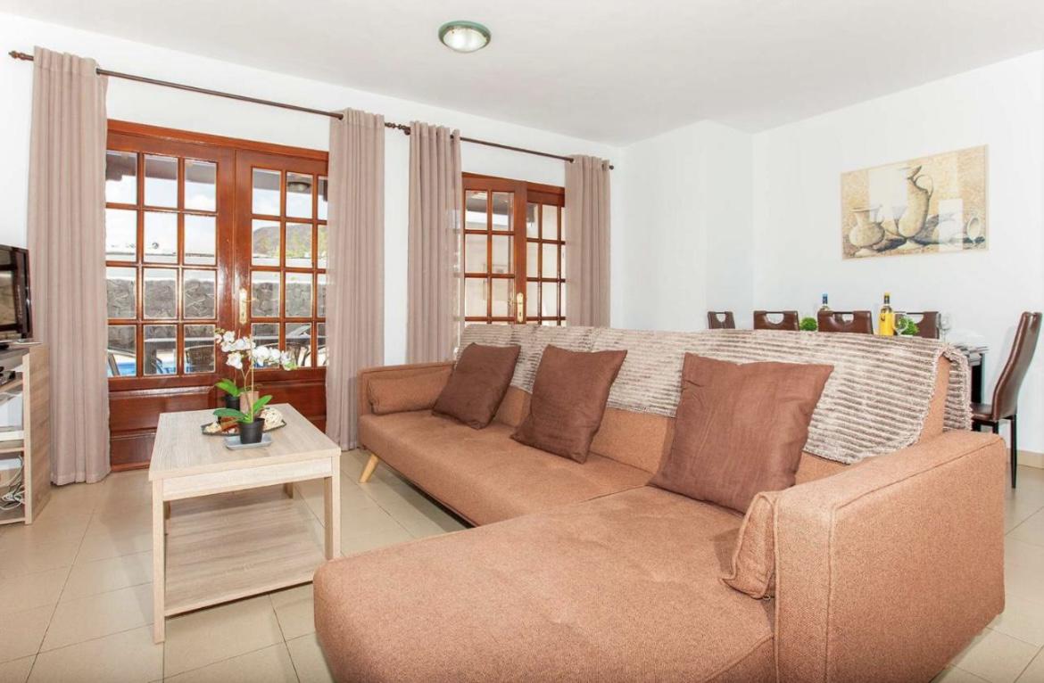 Open-plan living room with sofa, dining area, kitchen, WiFi internet, satellite TV