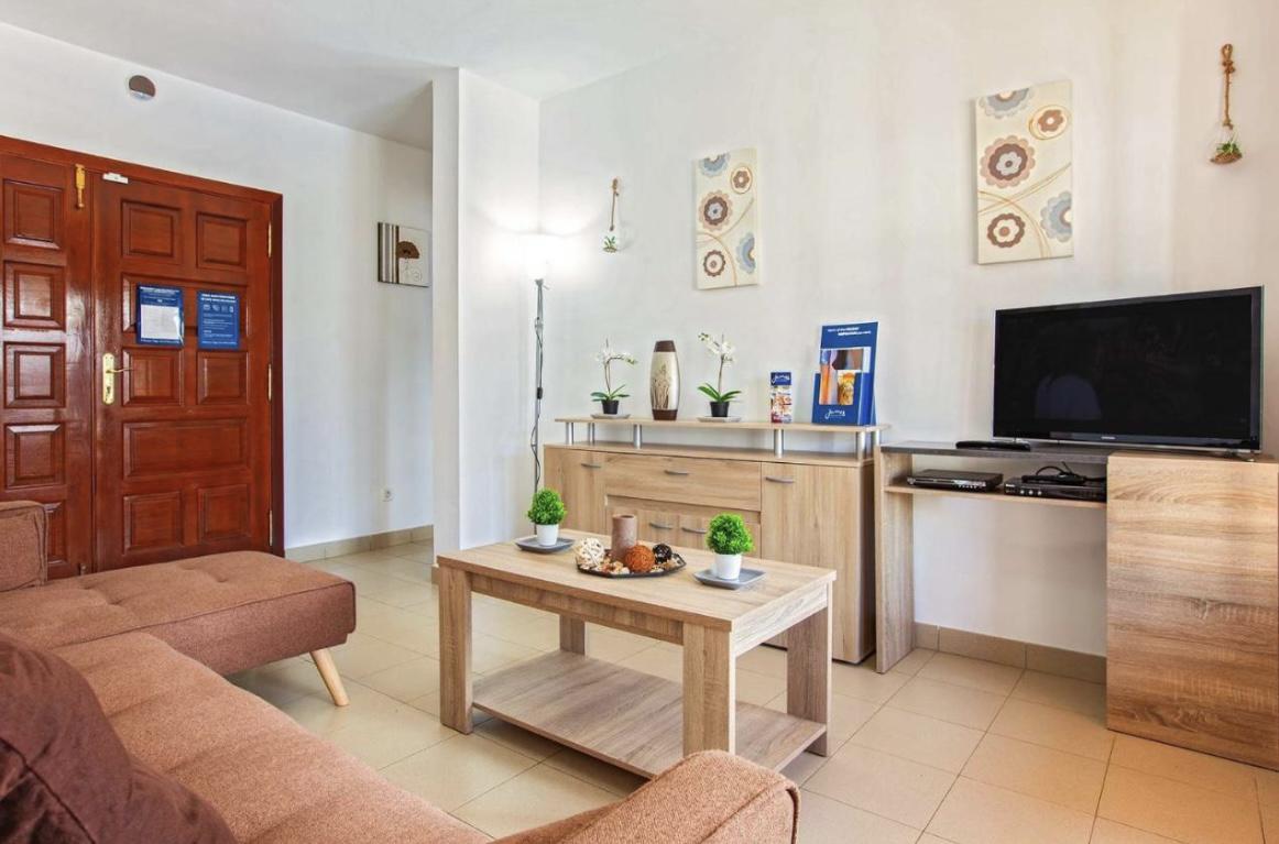 Open-plan living room with sofa, dining area, kitchen, WiFi internet, satellite TV
