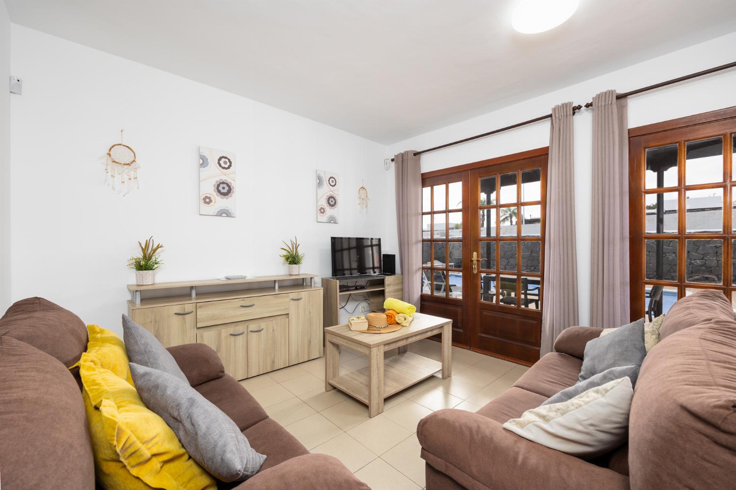 Living room with sofas, dining area, WiFi internet, and satellite TV