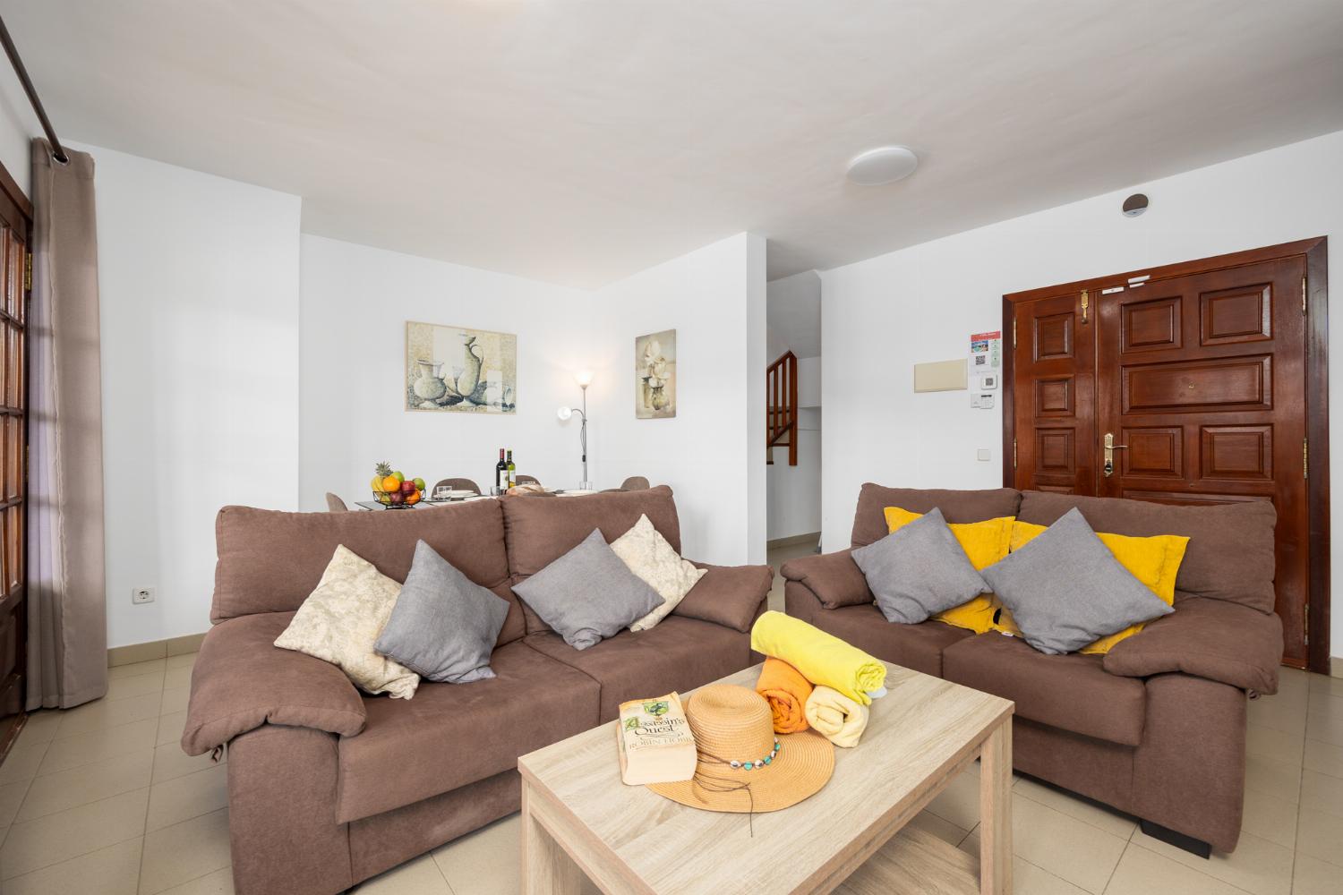 Living room with sofas, dining area, WiFi internet, and satellite TV
