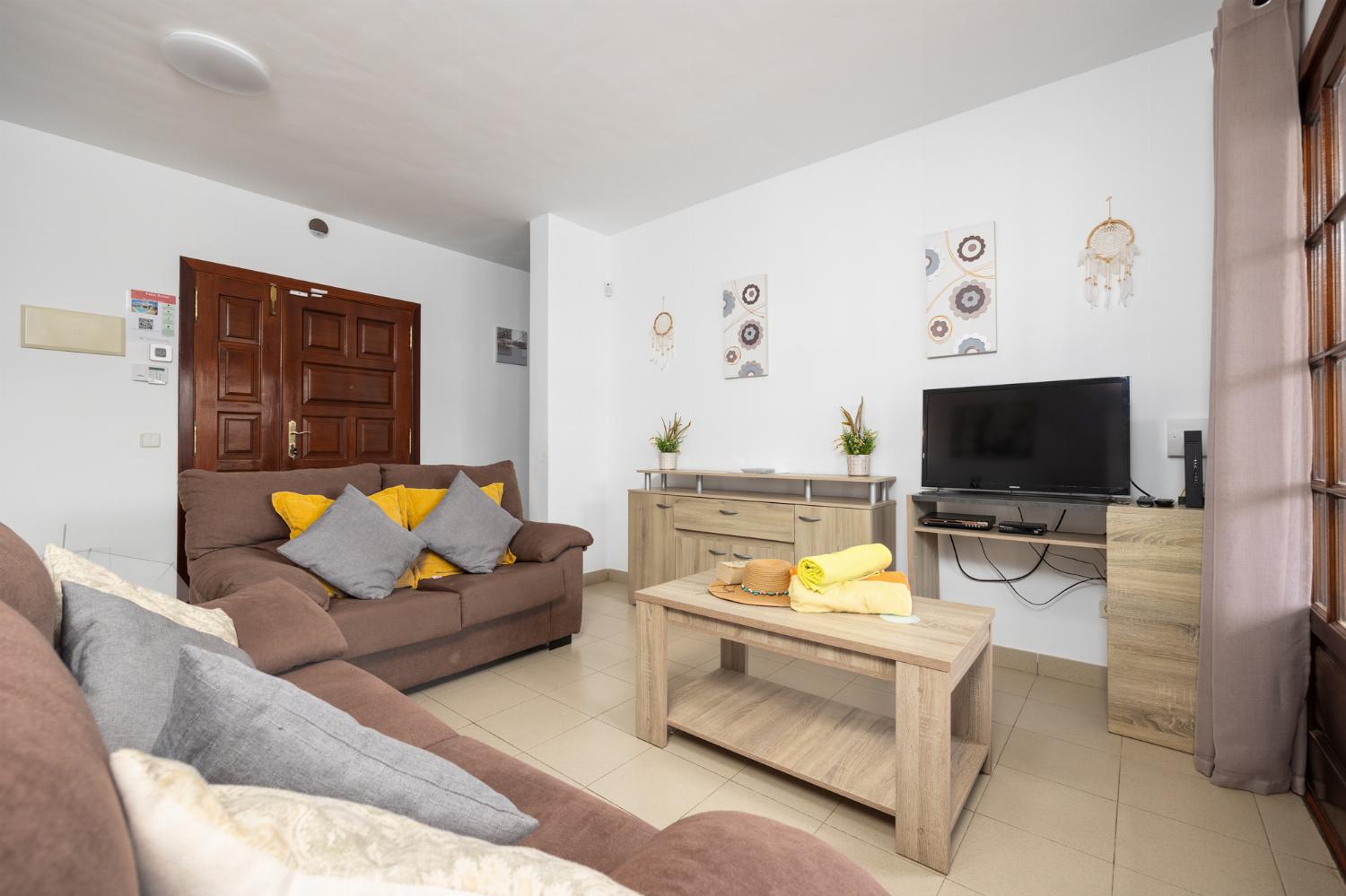 Living room with sofas, dining area, WiFi internet, and satellite TV