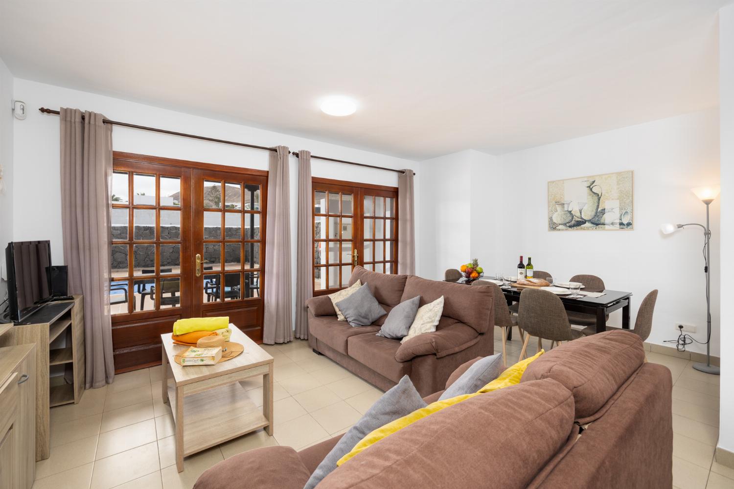 Living room with sofas, dining area, WiFi internet, and satellite TV