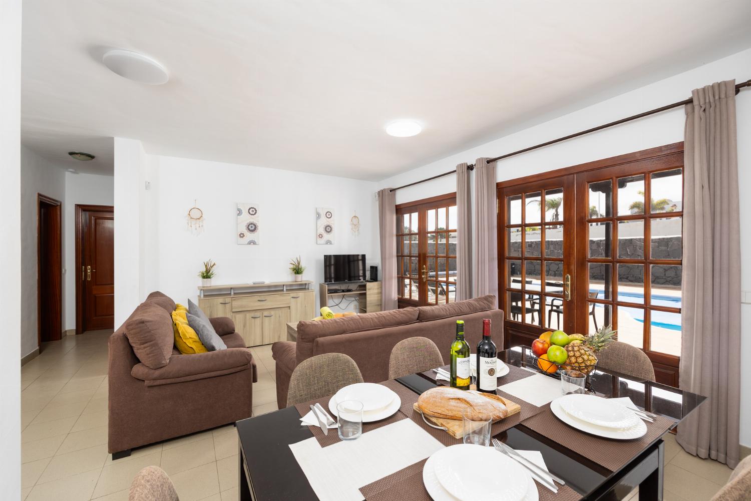 Living room with sofas, dining area, WiFi internet, and satellite TV