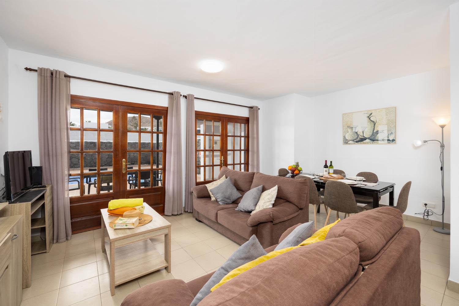 Living room with sofas, dining area, WiFi internet, and satellite TV