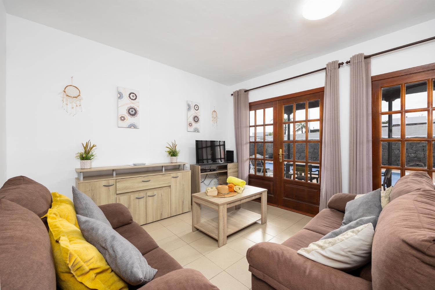 Living room with sofas, dining area, WiFi internet, and satellite TV