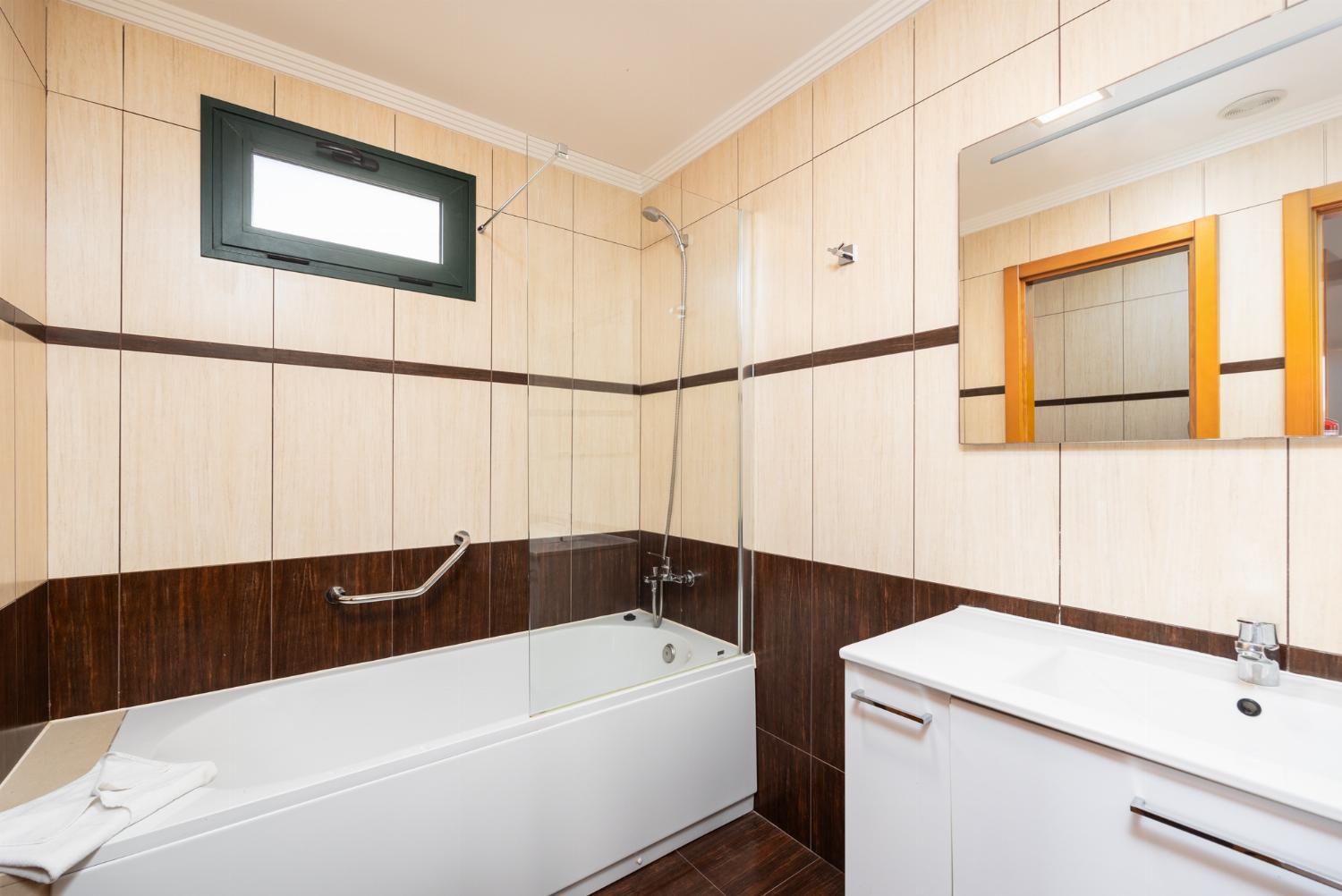 En suite bathroom with bath and shower