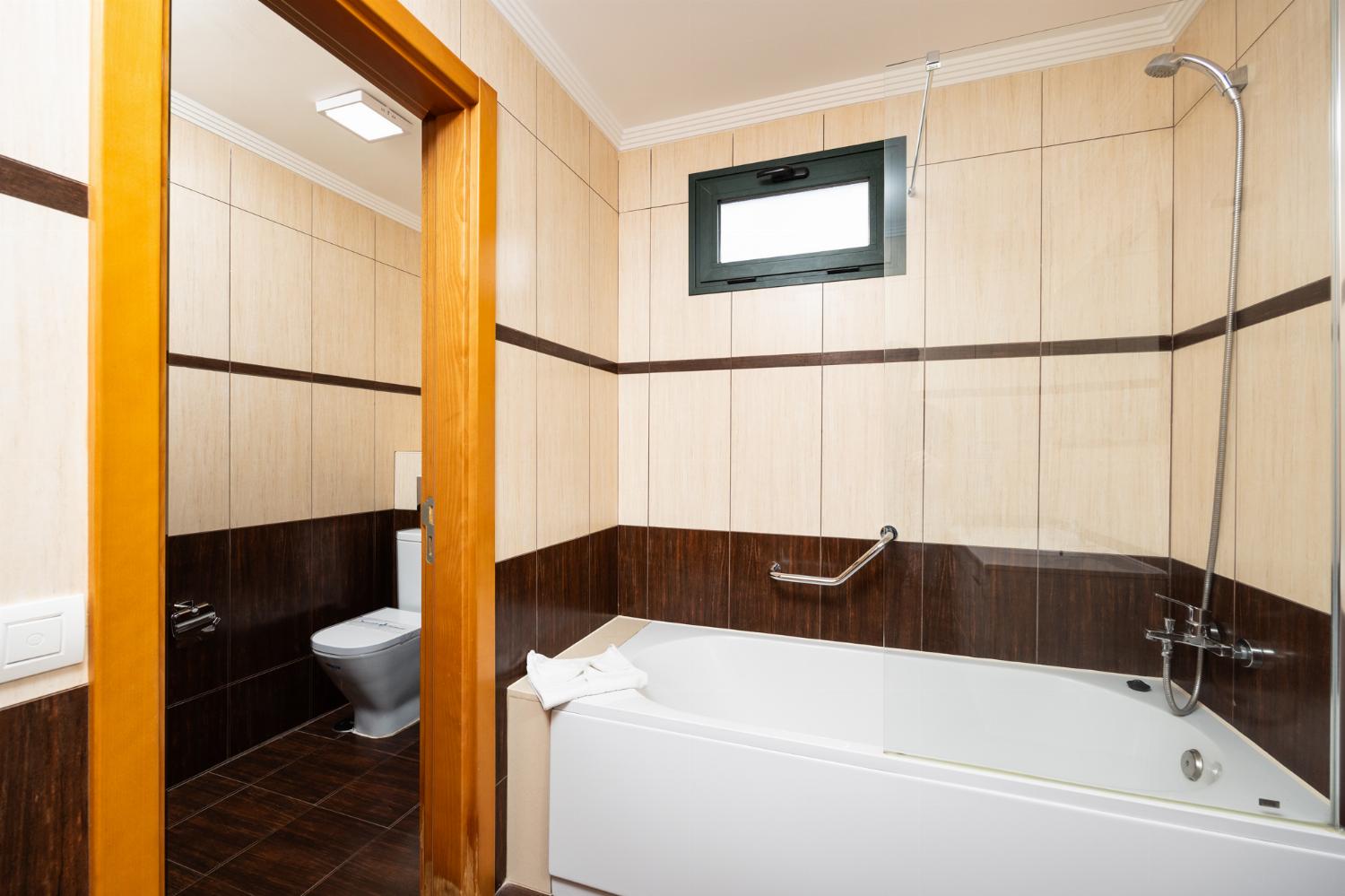 En suite bathroom with bath and shower