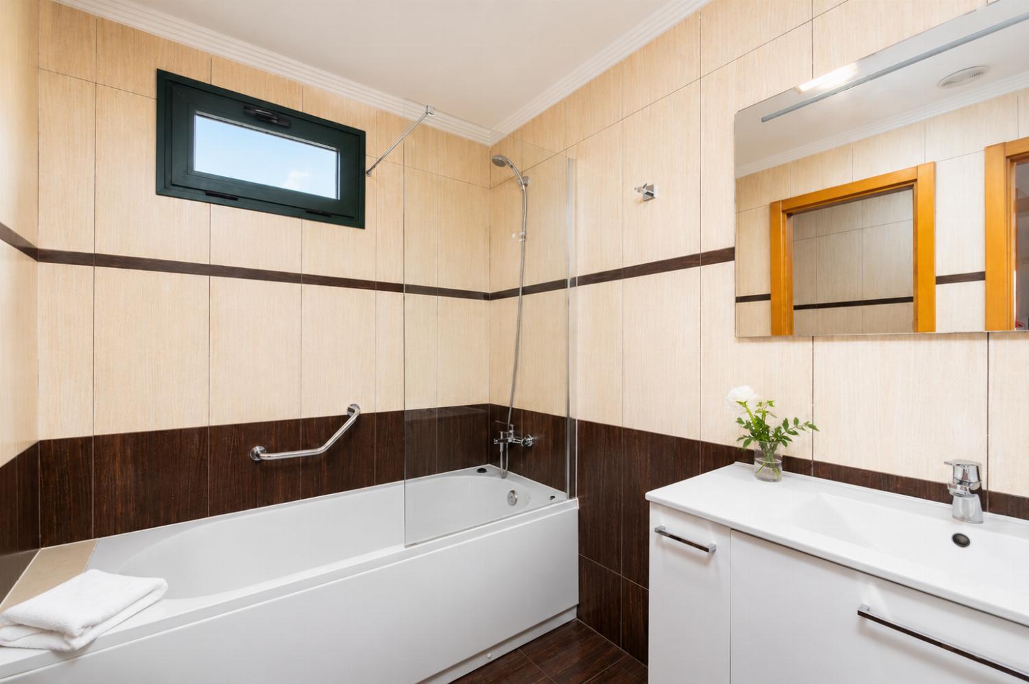 En suite bathroom with bath and shower