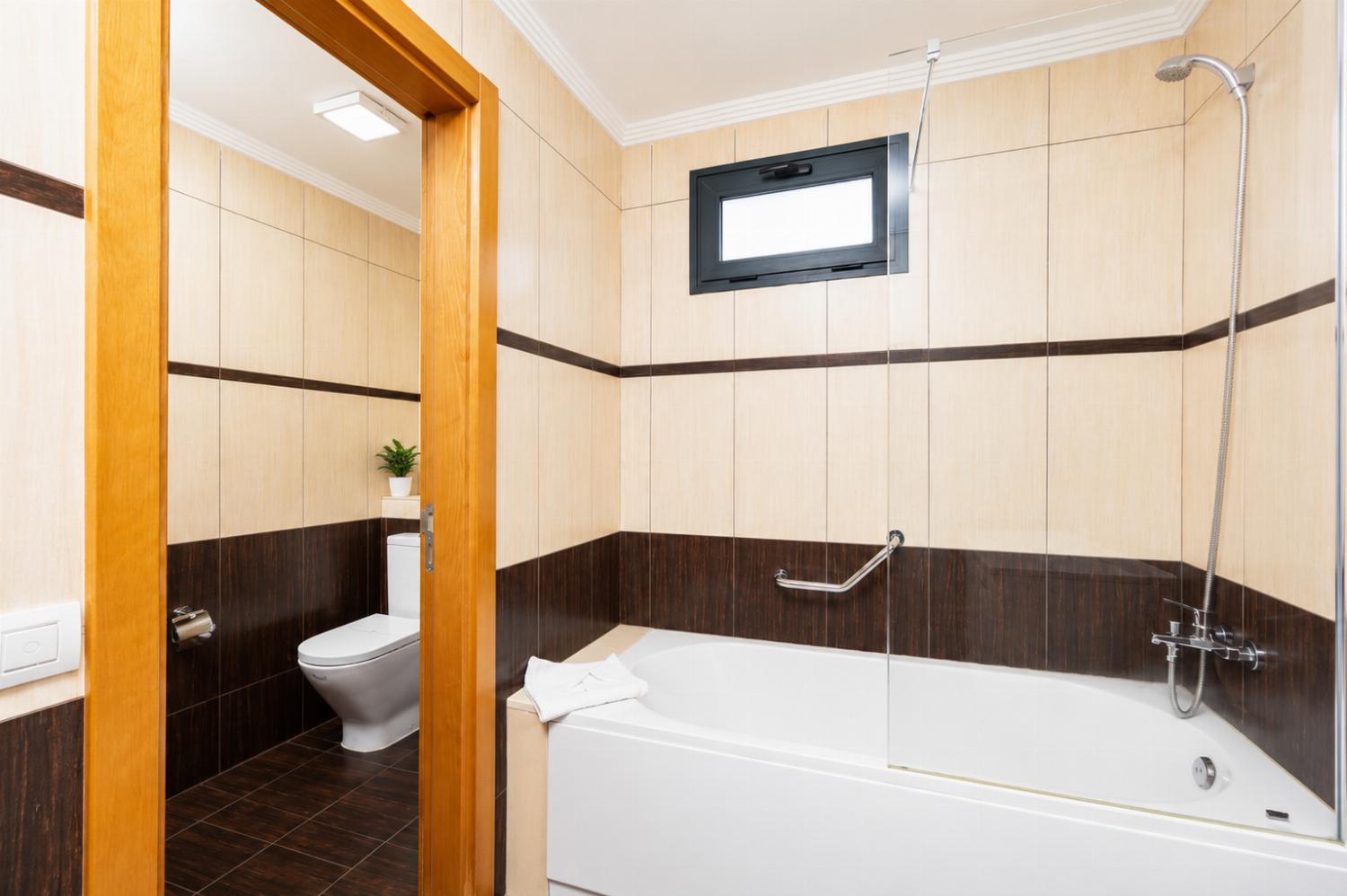 En suite bathroom with bath and shower