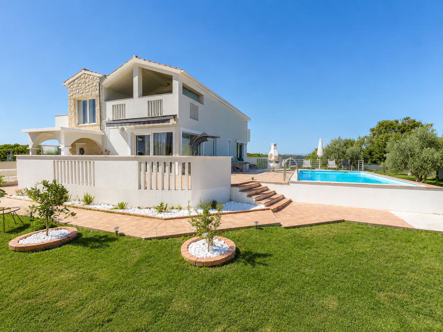 Modern Mediterranean villa features a glowing two-story layout.