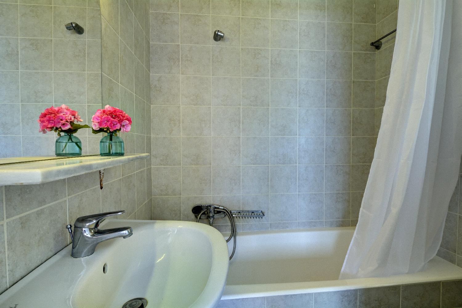 En-suite bathroom with a bath 
