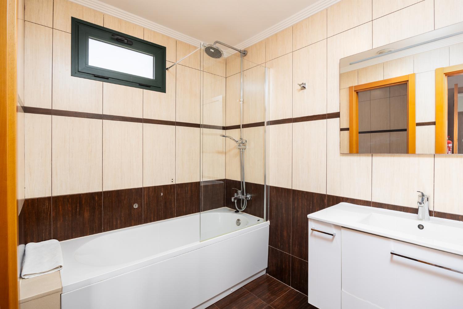 En suite bathroom with bath and shower