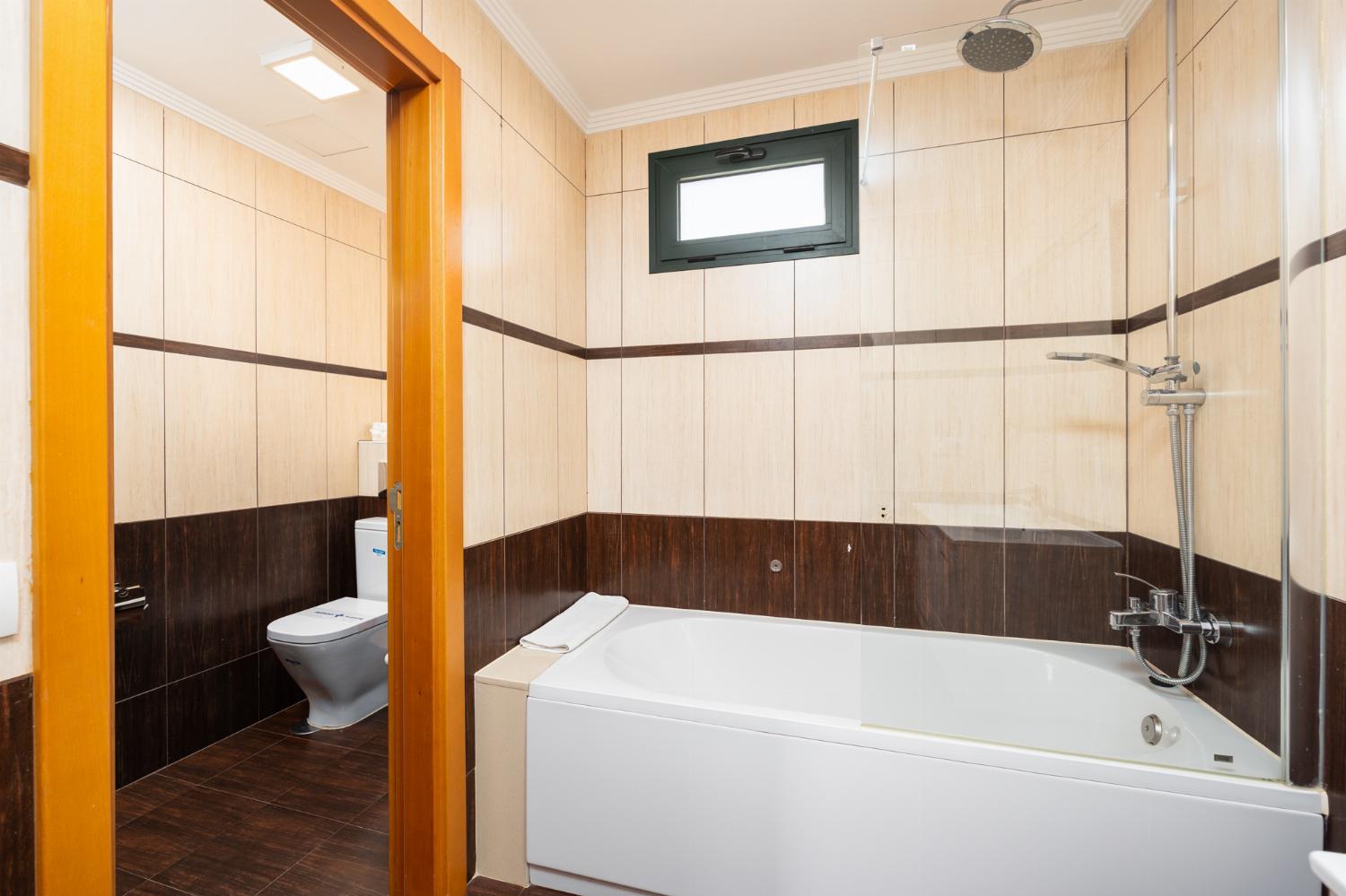 En suite bathroom with bath and shower