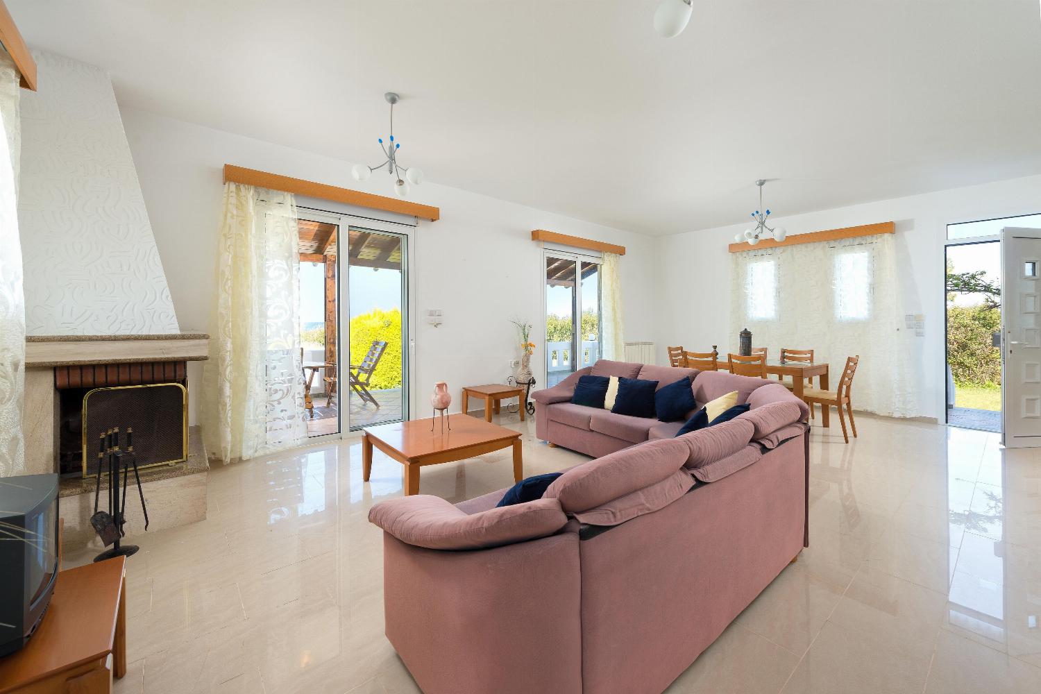 Open plan living room with comfortable sitting dining area TV
