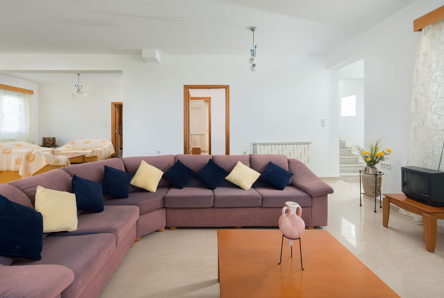 Open plan living room with comfortable sitting dining area TV
