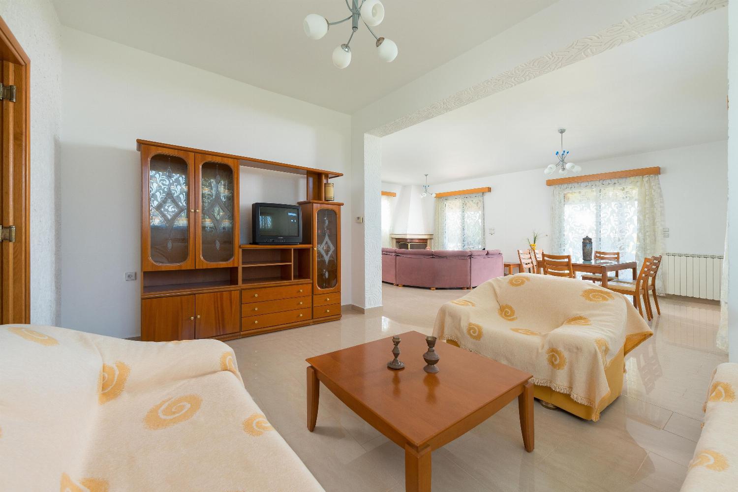 Open plan living room with comfortable sitting dining area TV