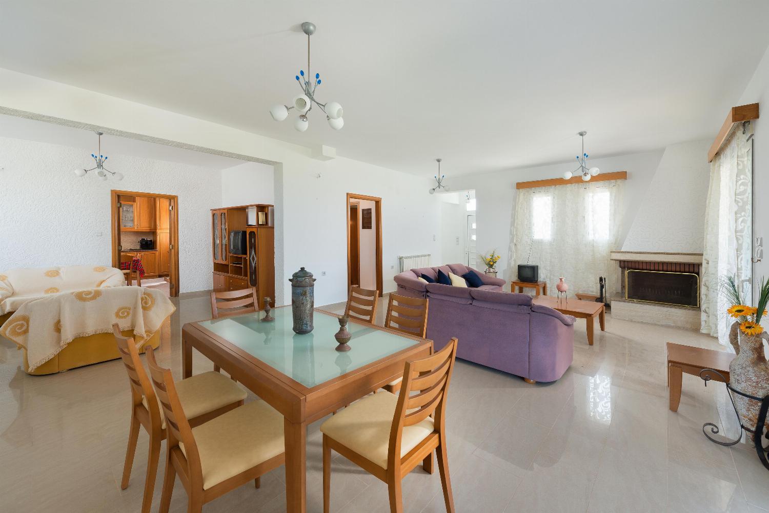 Open plan living room with comfortable sitting dining area TV