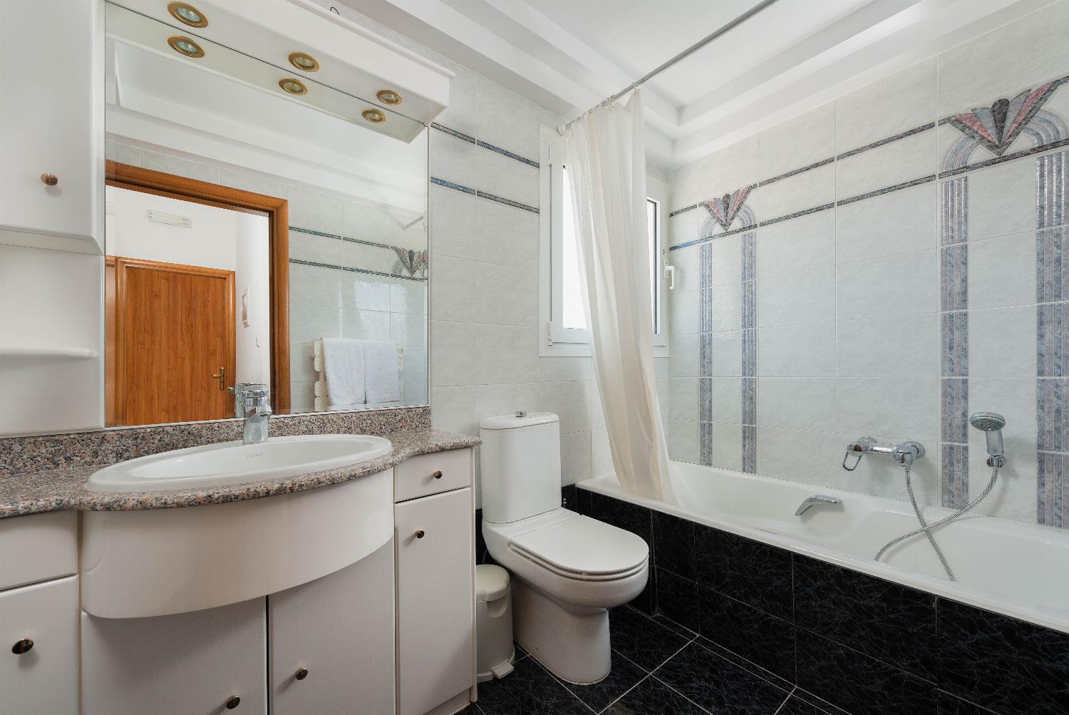 En suite bathroom with bath and WC