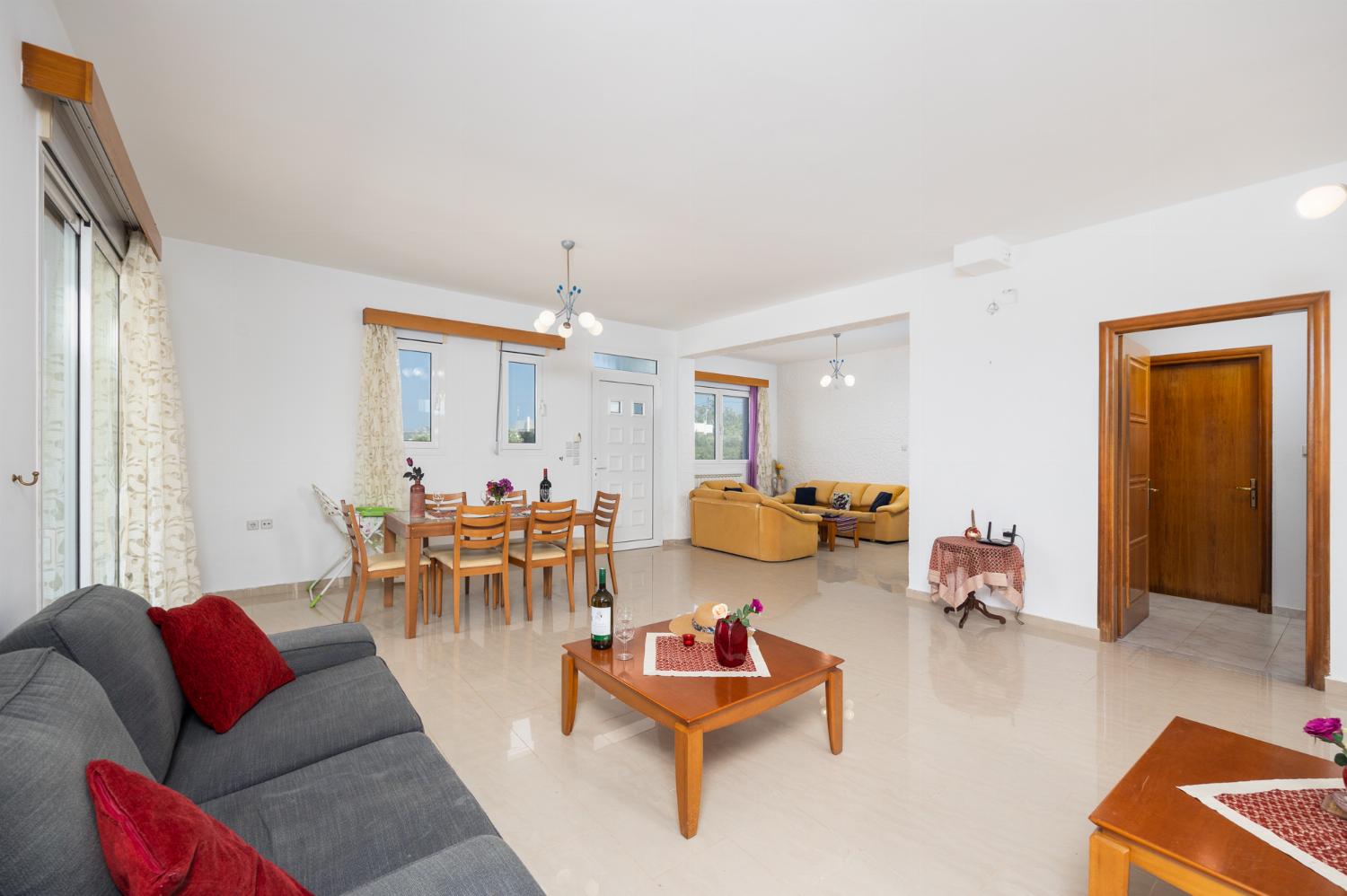 Living room with sofas, dining area, ornamental fireplace, A/C, WiFi internet, and satellite TV