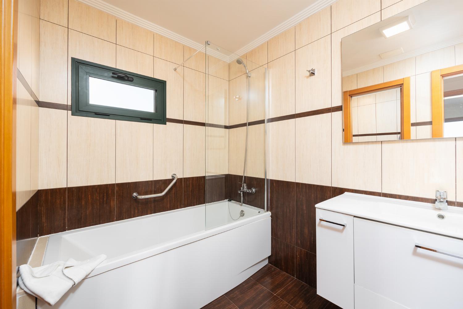 En suite bathroom with bath and shower