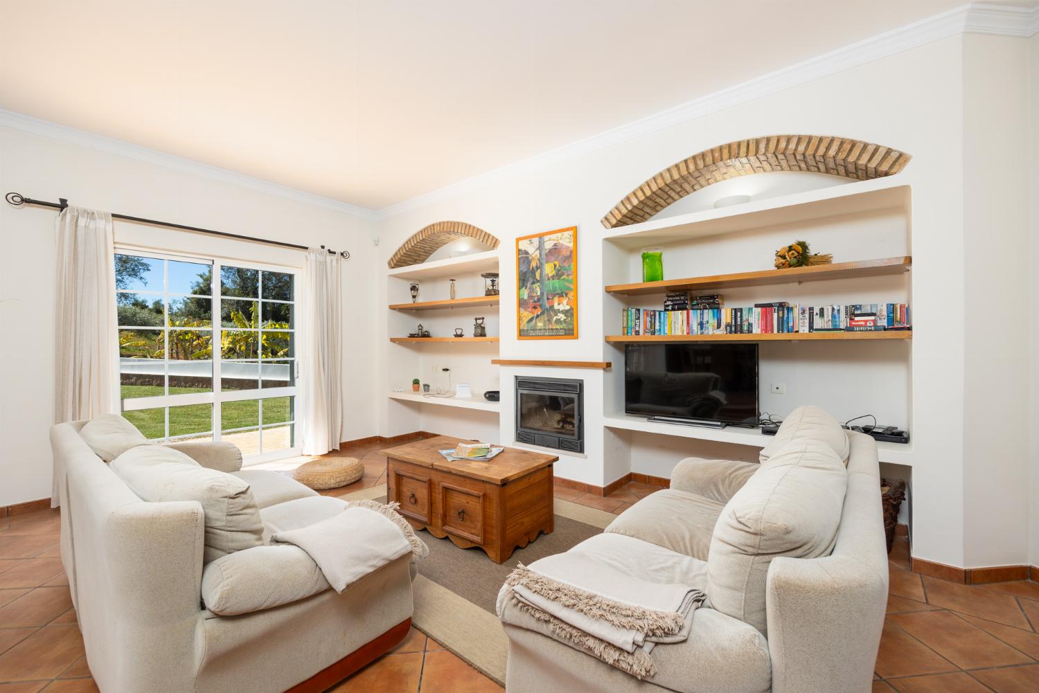 Living room with sofas, dining area, ornamental fireplace, WiFi internet, and satellite TV