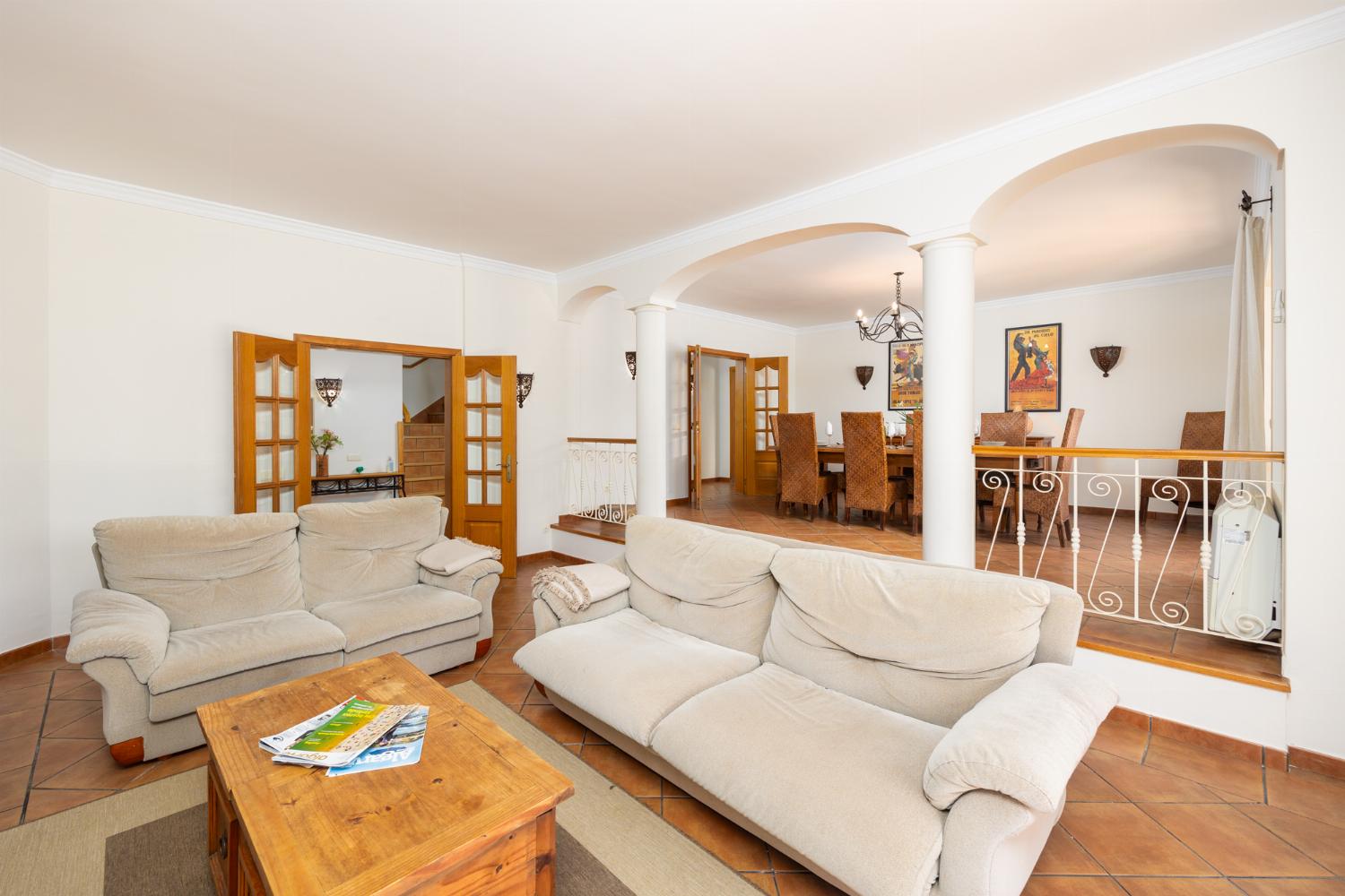Living room with sofas, dining area, ornamental fireplace, WiFi internet, and satellite TV