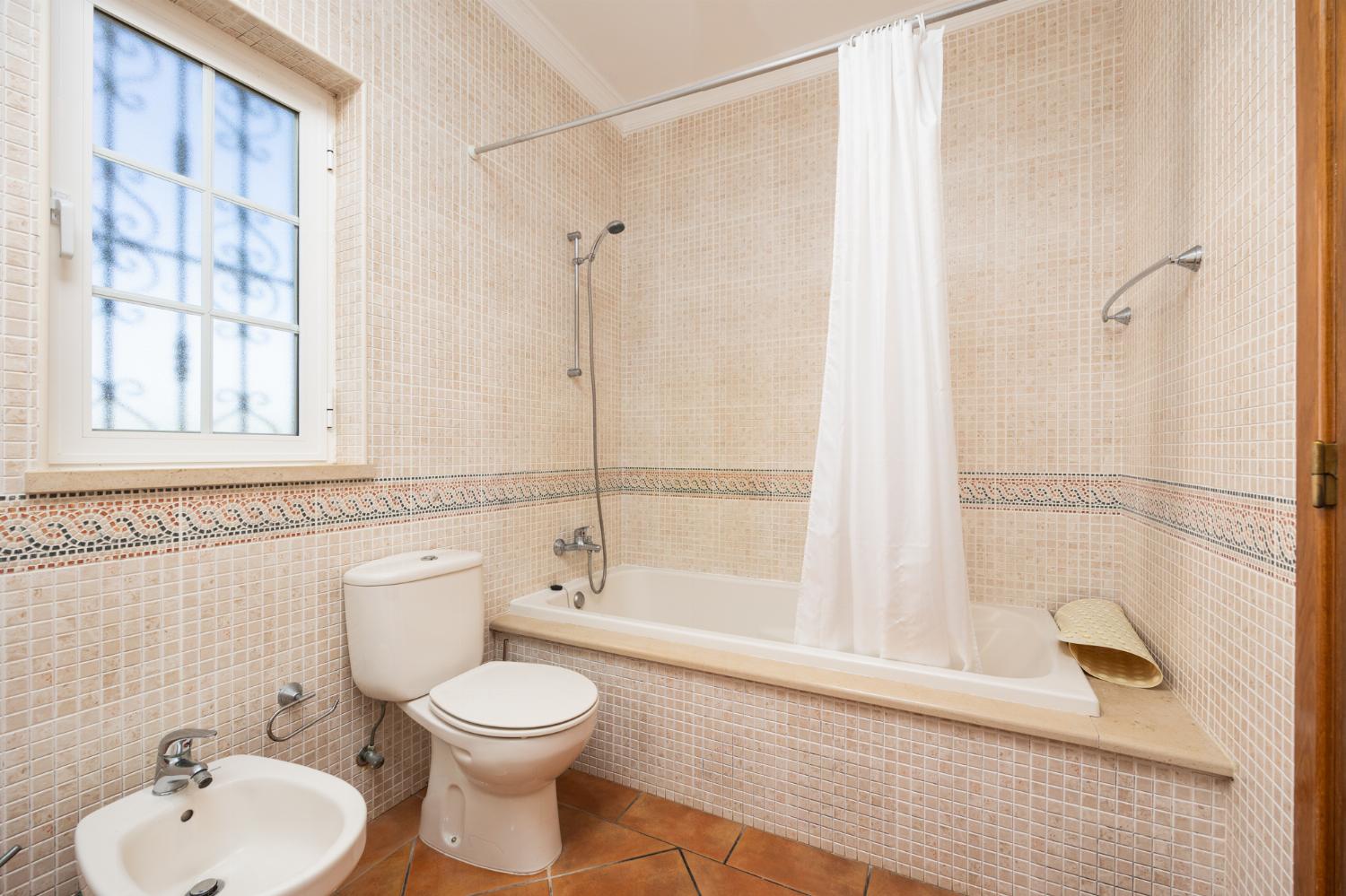 En suite bathroom with bath and shower