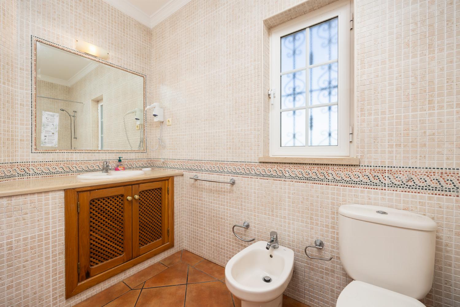 En suite bathroom with bath and shower