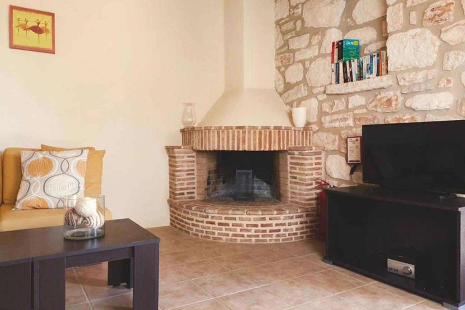 Open plan living room with ornamental fireplace, TV, WiFi, comfortable sofas