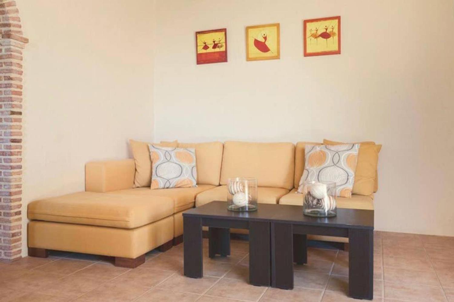 Open plan living room with ornamental fireplace, TV, WiFi, comfortable sofas