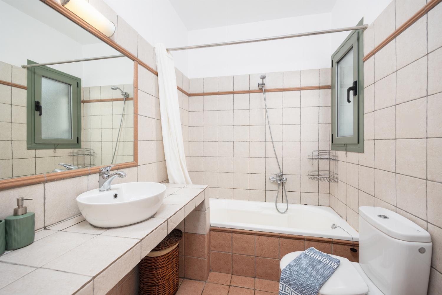 En suite bathroom with bath and shower