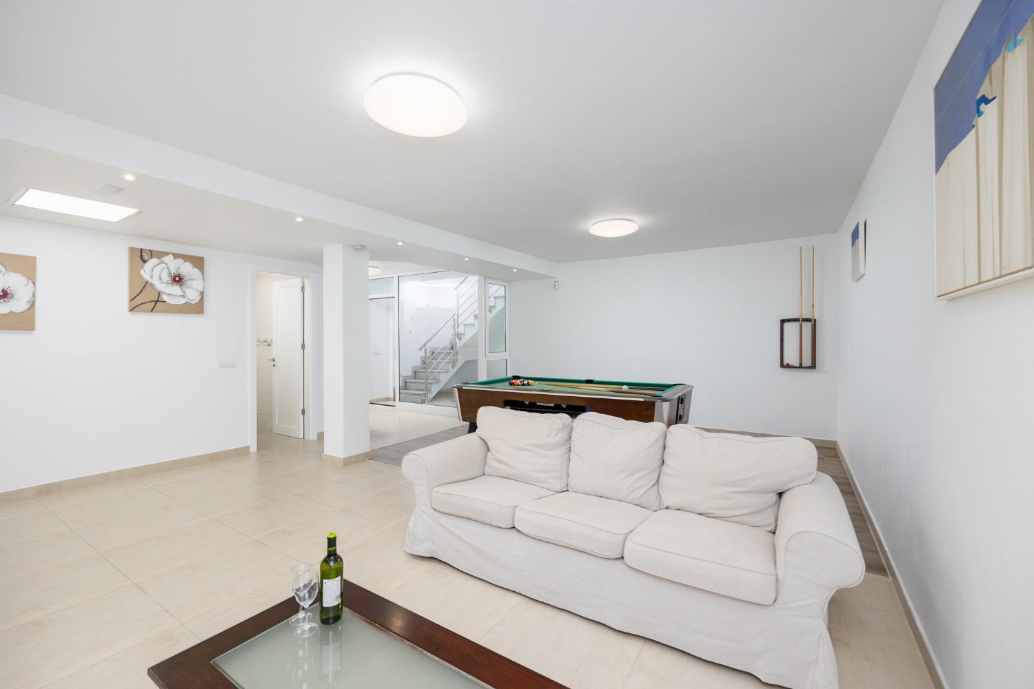 Living area with sofa, kitchenette, pool table, WiFi internet, and satellite TV