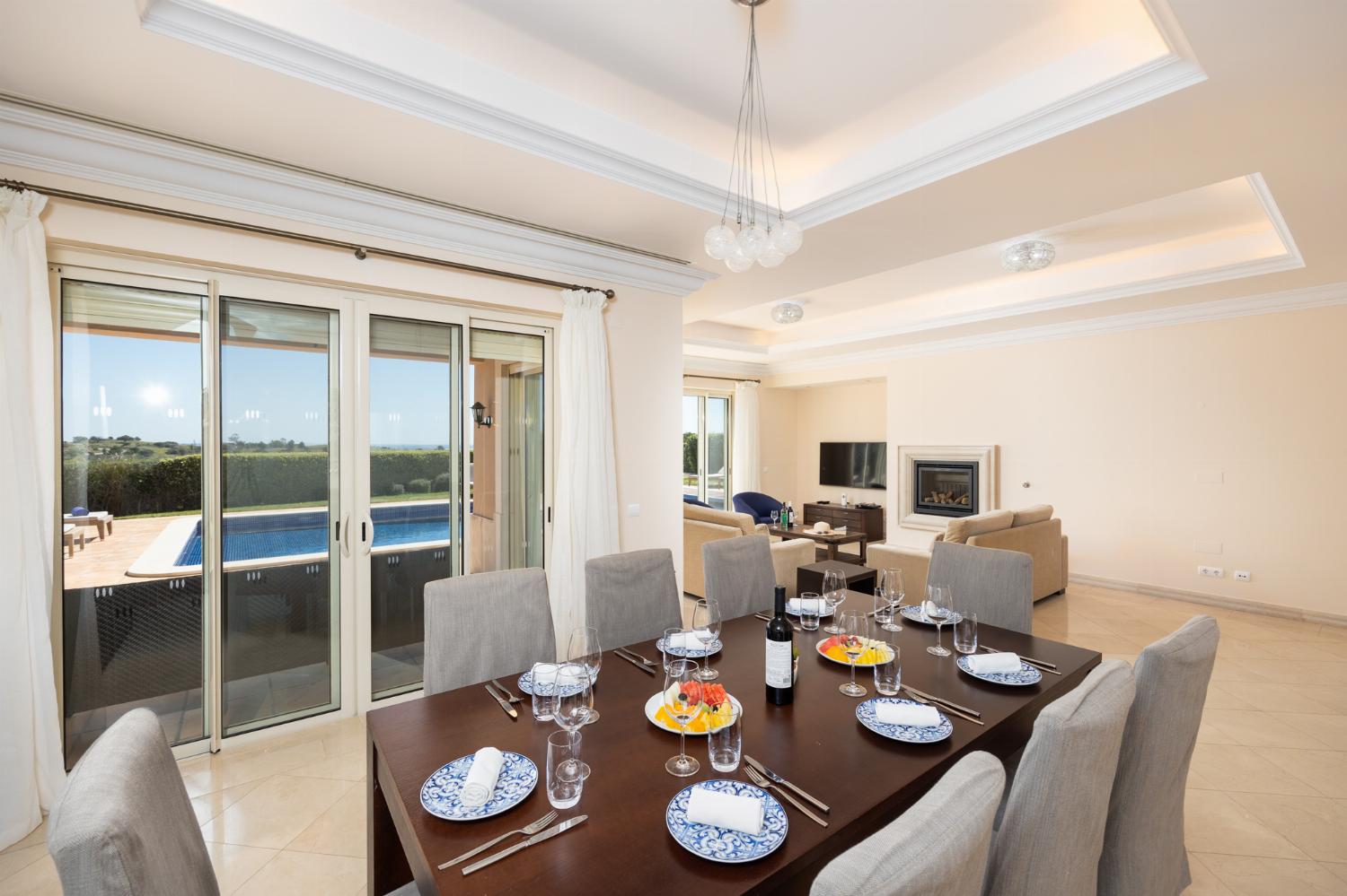 Living room with sofas, dining area, ornamental fireplace, A/C, WiFi internet, and satellite TV