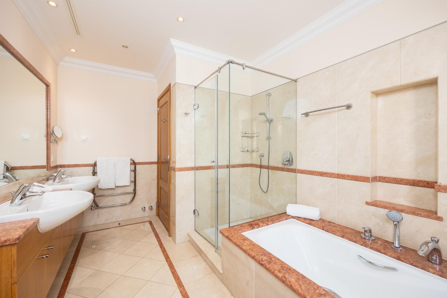 En suite bathroom with bath and shower