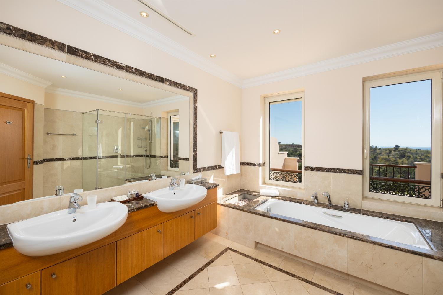 En suite bathroom with bath and shower