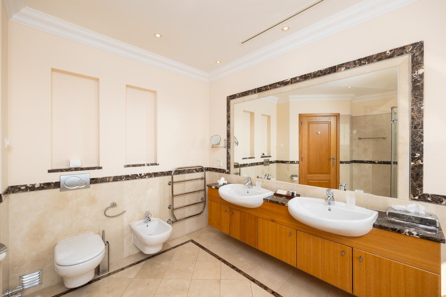 En suite bathroom with bath and shower