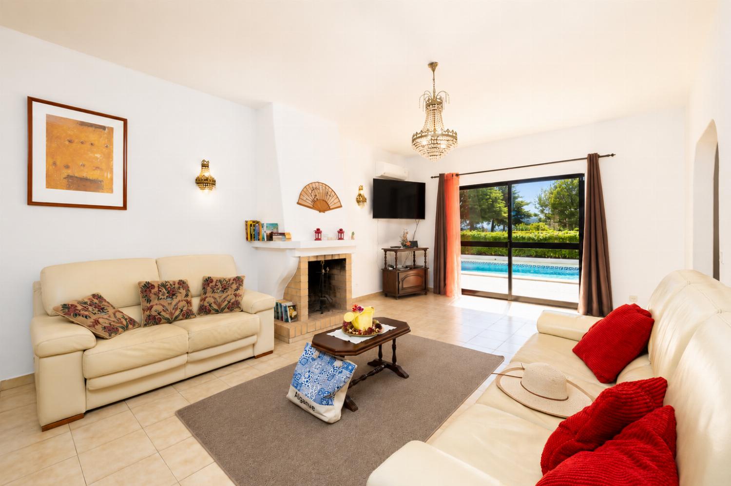 Living room with sofas, ornamental fireplace, A/C, WiFi internet, and satellite TV