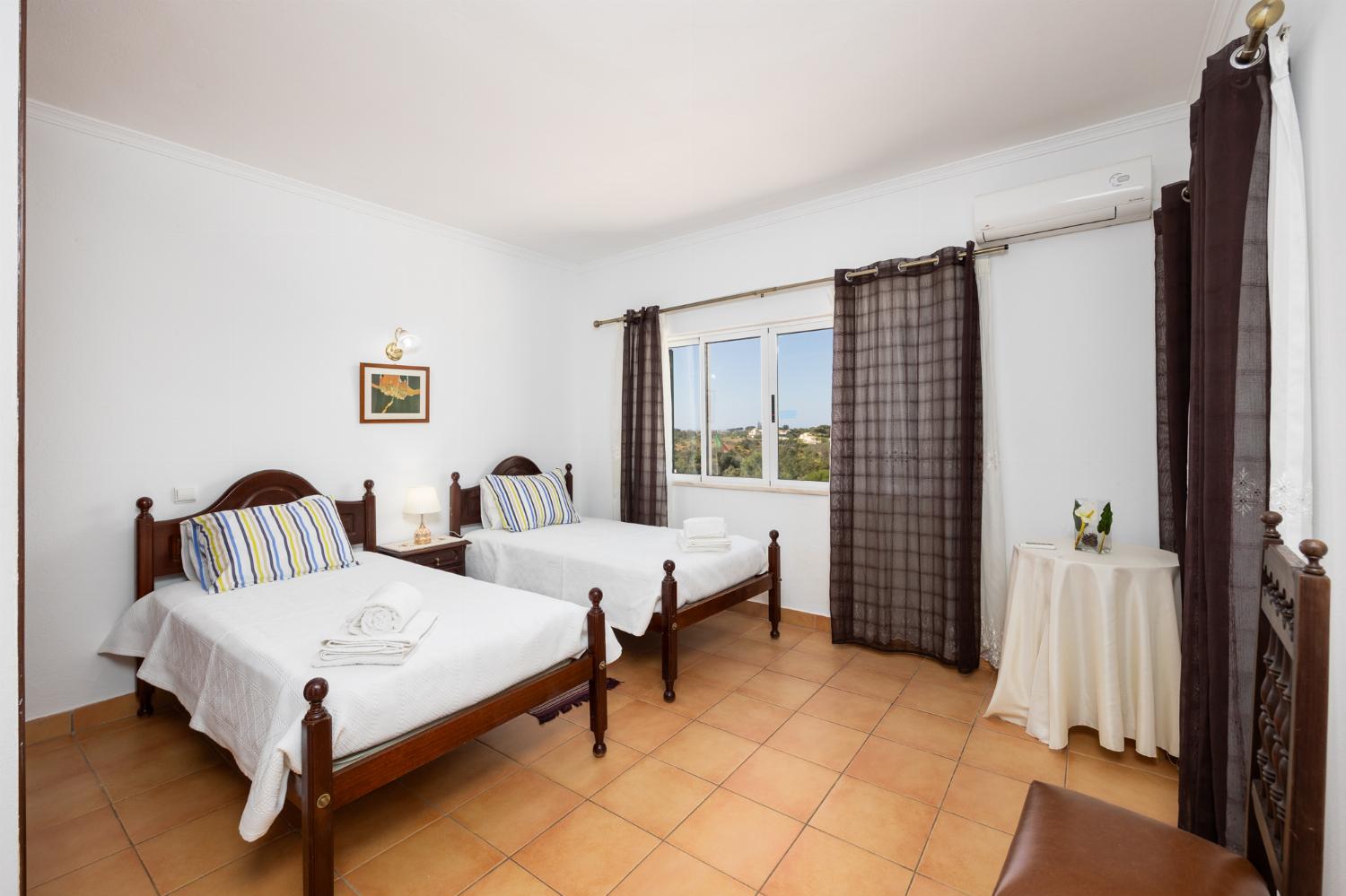 Twin bedroom with en suite bathroom and A/C