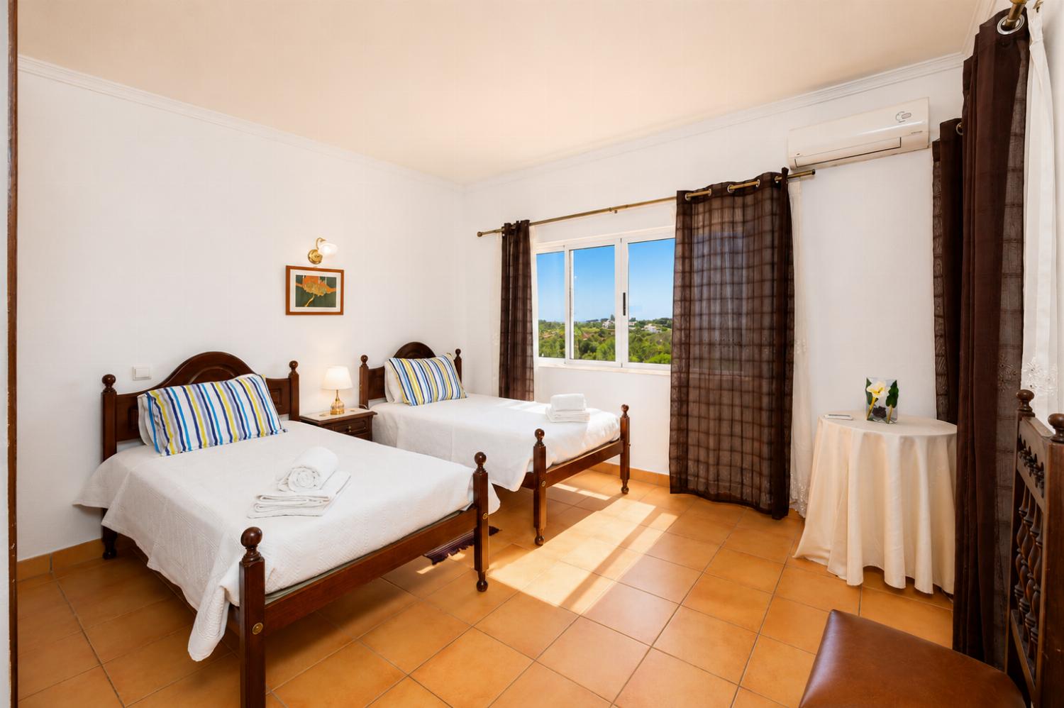Twin bedroom with en suite bathroom and A/C