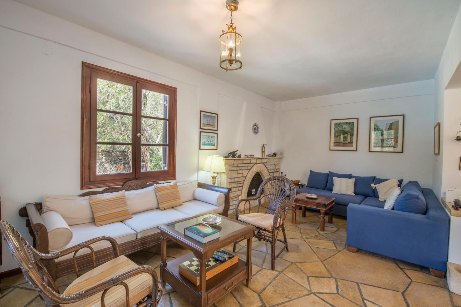 Open plan living room with comfortable sofas, WiFi, TV, and dining area