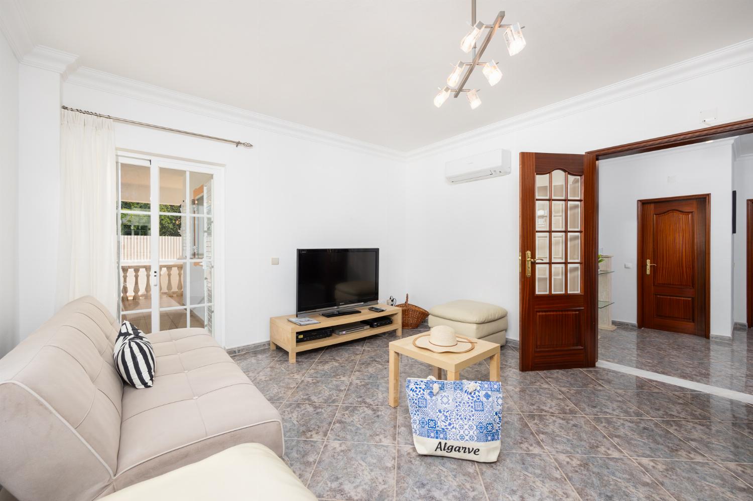 Living room with sofas, A/C, WiFi internet, and satellite TV