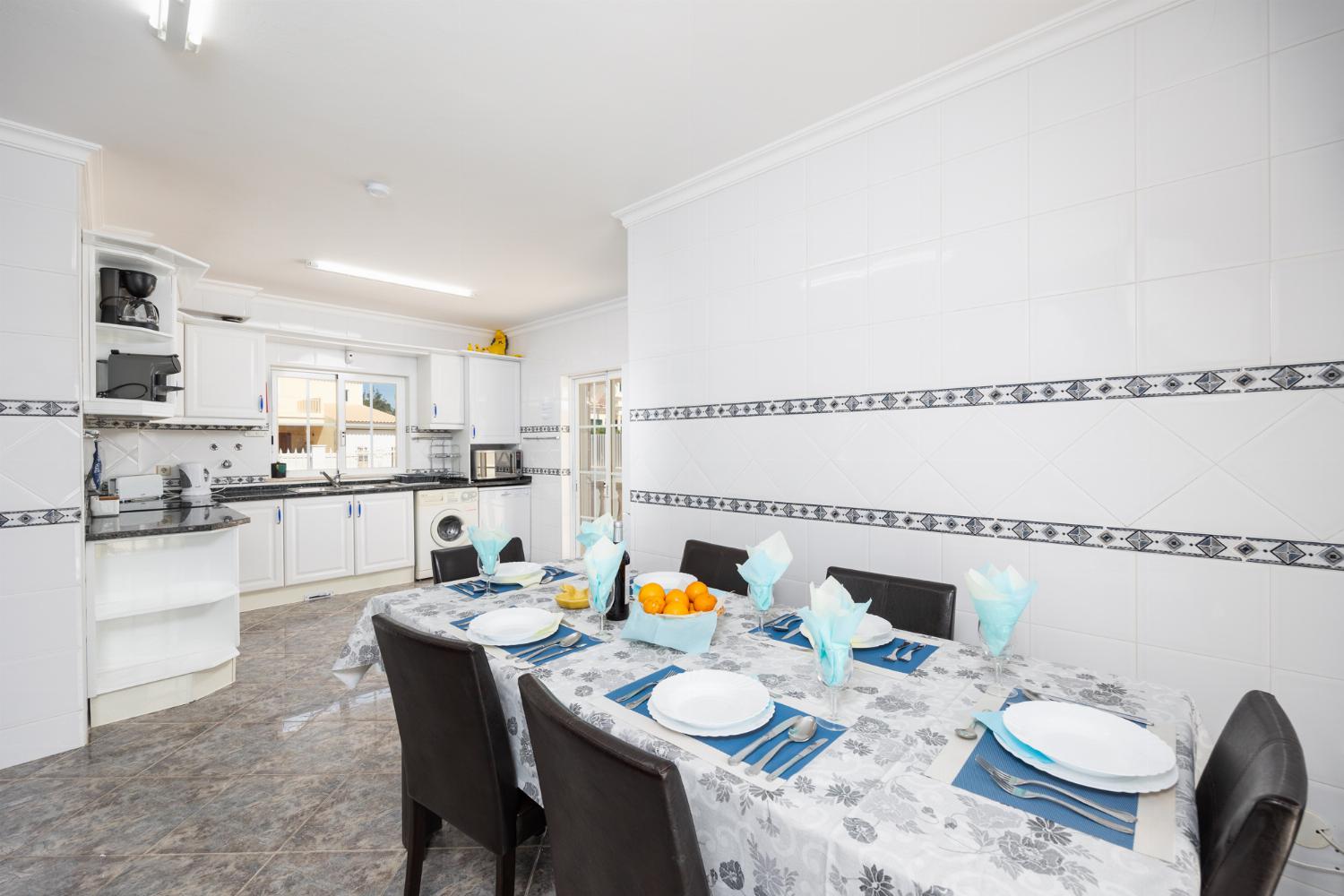 Dining area with sofa, ornamental fireplace, A/C, and TV