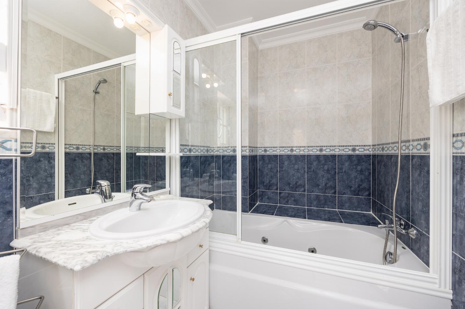 En suite bathroom with bath and shower