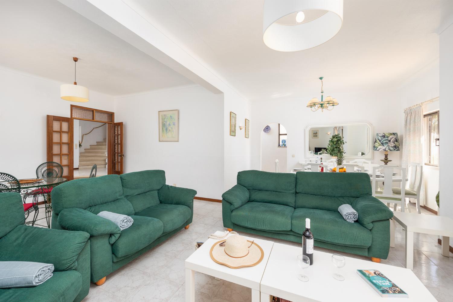 Living room with sofas, dining area, ornamental fireplace, WiFi internet, and satellite TV