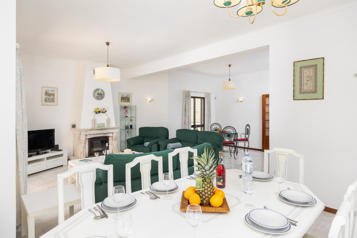Living room with sofas, dining area, ornamental fireplace, WiFi internet, and satellite TV