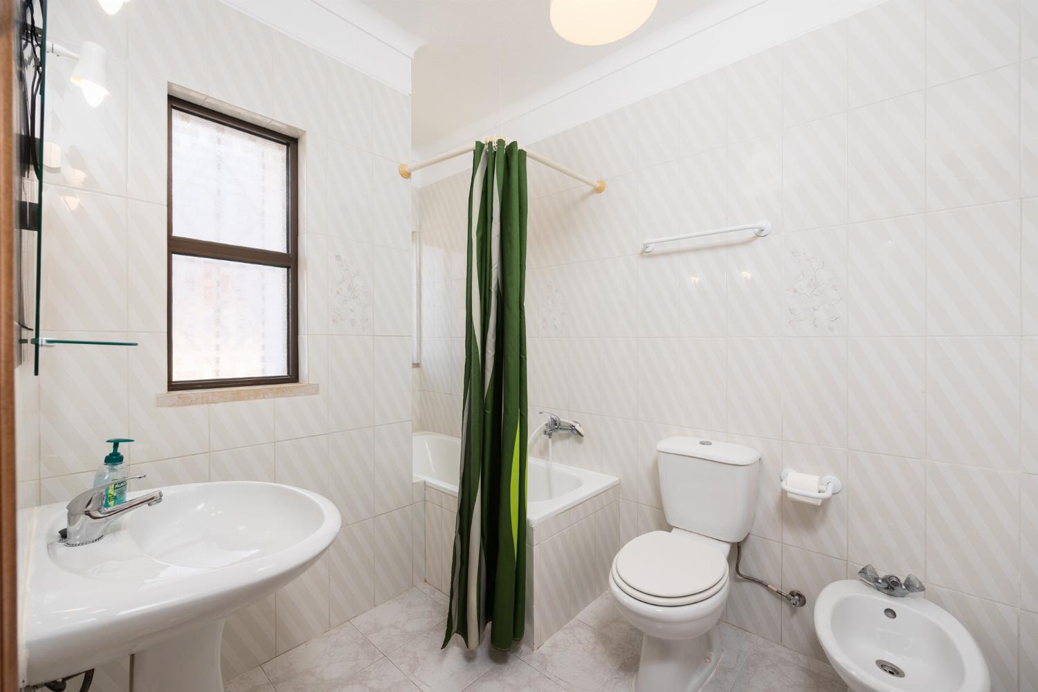 En suite bathroom with bath and shower