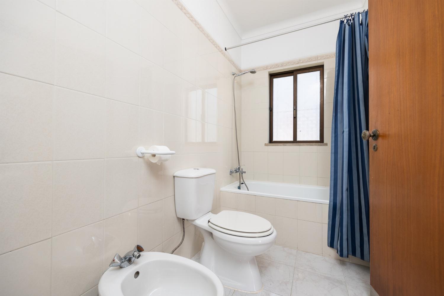 En suite bathroom with bath and shower