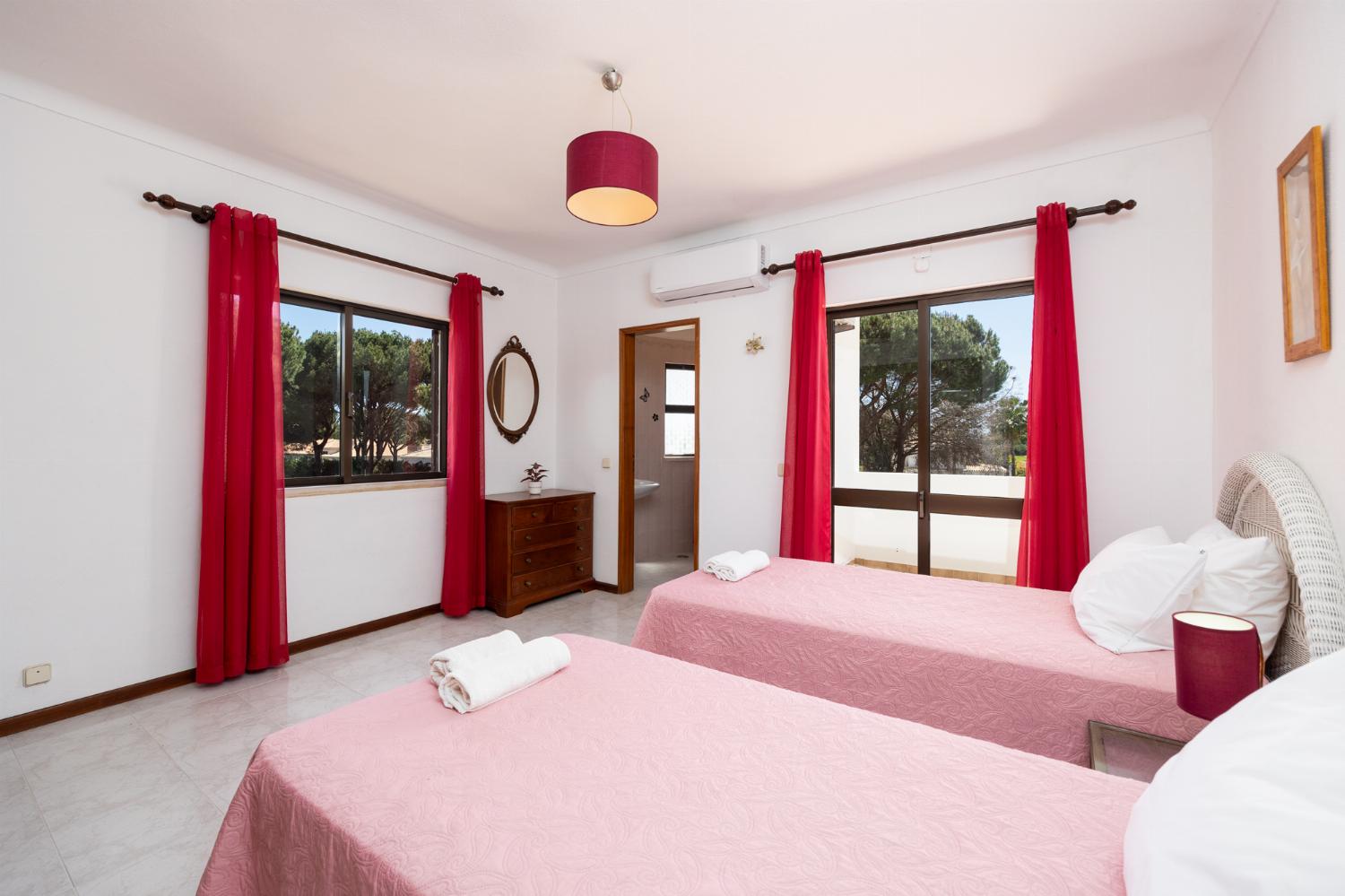 Twin bedroom with en suite bathroom and A/C
